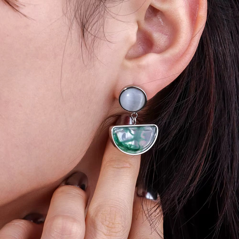 Green and silver statement earrings on model