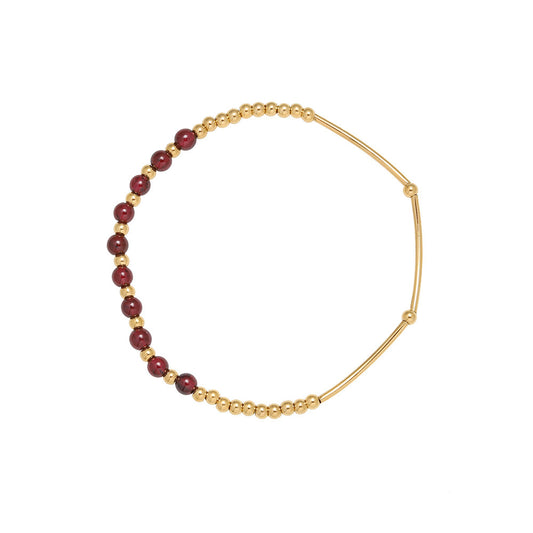 Gazania garnet bracelet with gold stainless steel beads on white background