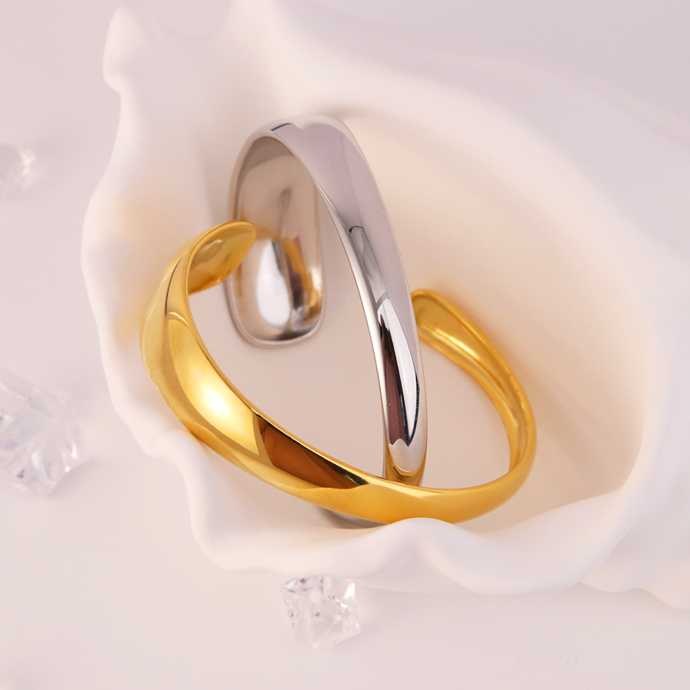 Gold and silver Magnolia statement cuff bracelets